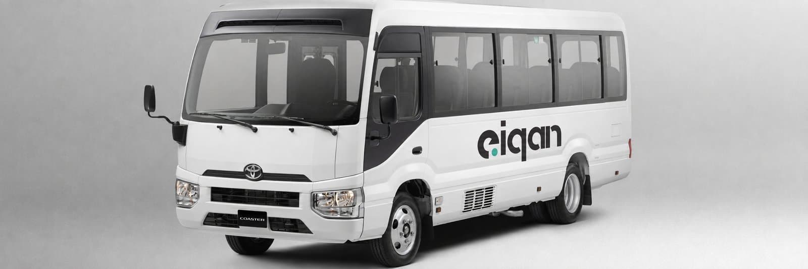 EIQAN-branded rental coaster bus, studio shot